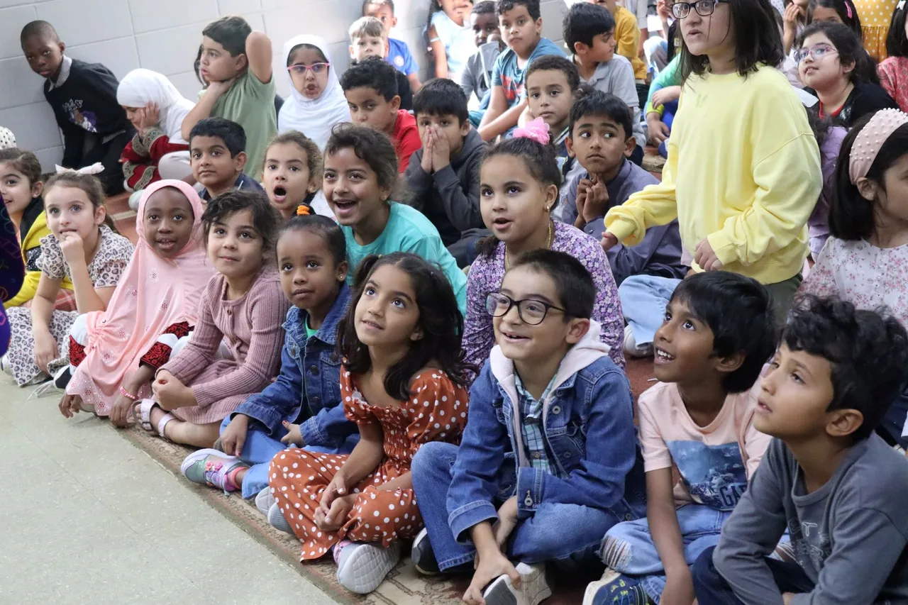 Intellicor students listening at a school assembly